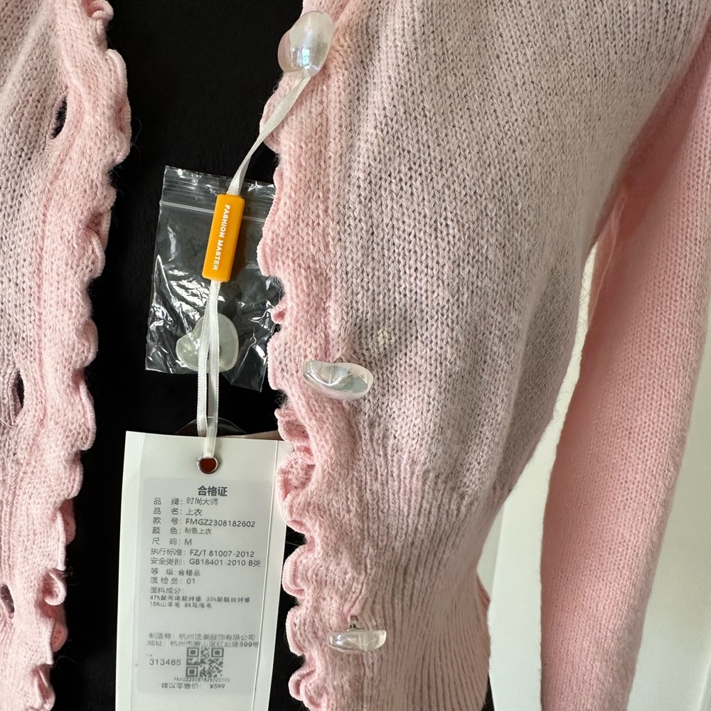 Pink sweater, medium but will fit a small